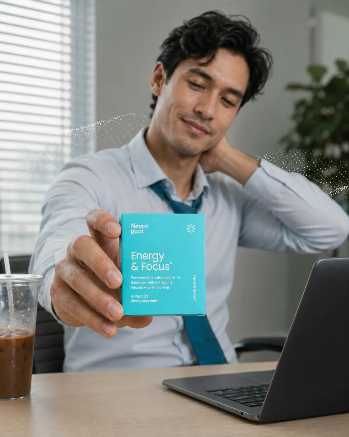 Tired office worker slumped at a desk reaching for a natural pick-me-up to beat the afternoon slump